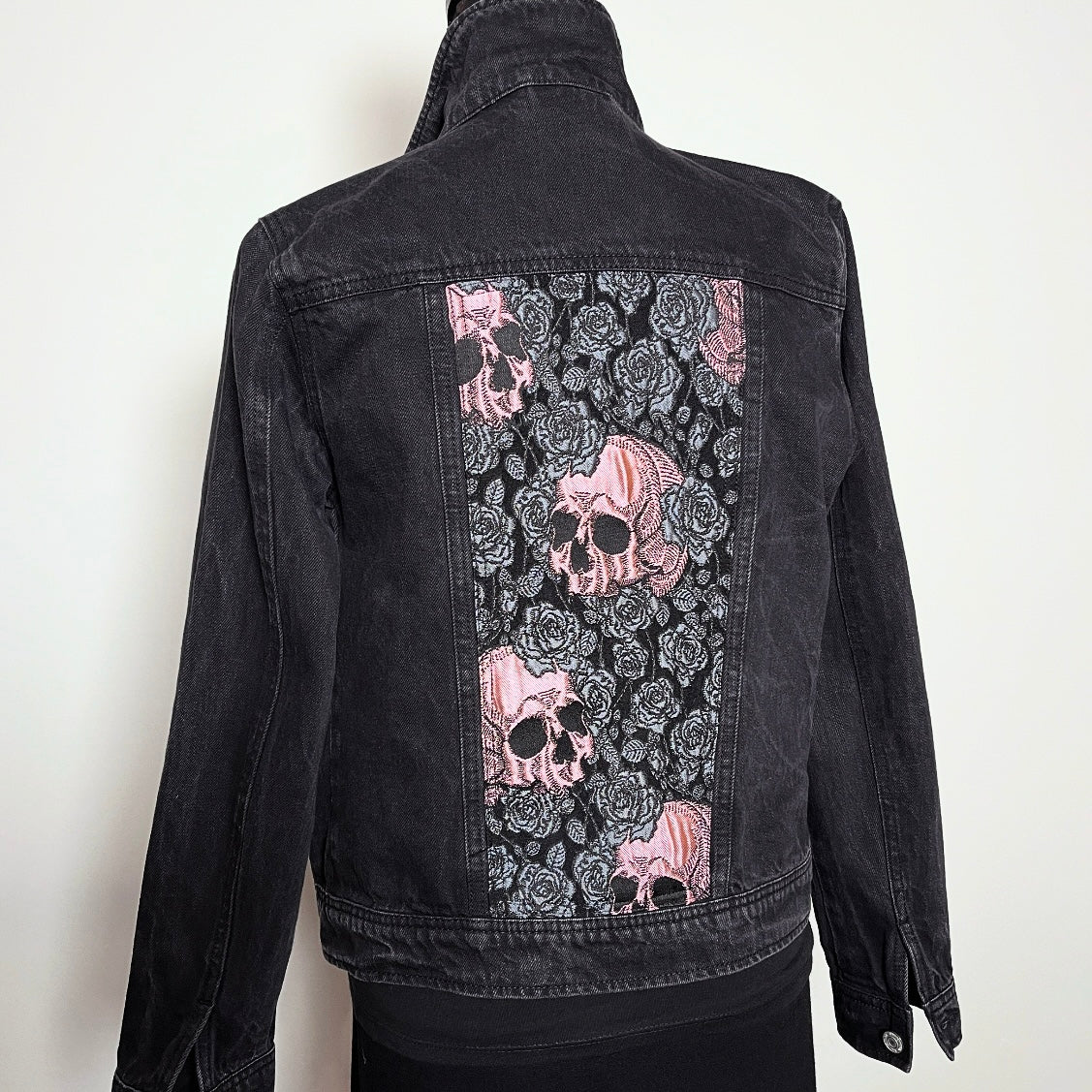 Upcycled black denim jacket with skulls and roses in pink