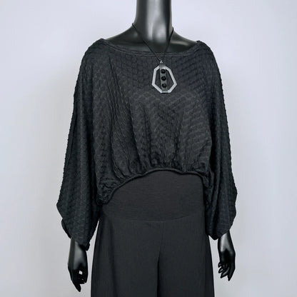 Black textured knit top with bat wing sleeves and gathered hemline black rubber necklace made in Melbourne 