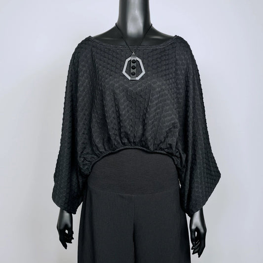 Black textured knit top with bat wing sleeves and gathered hemline black rubber necklace made in Melbourne 