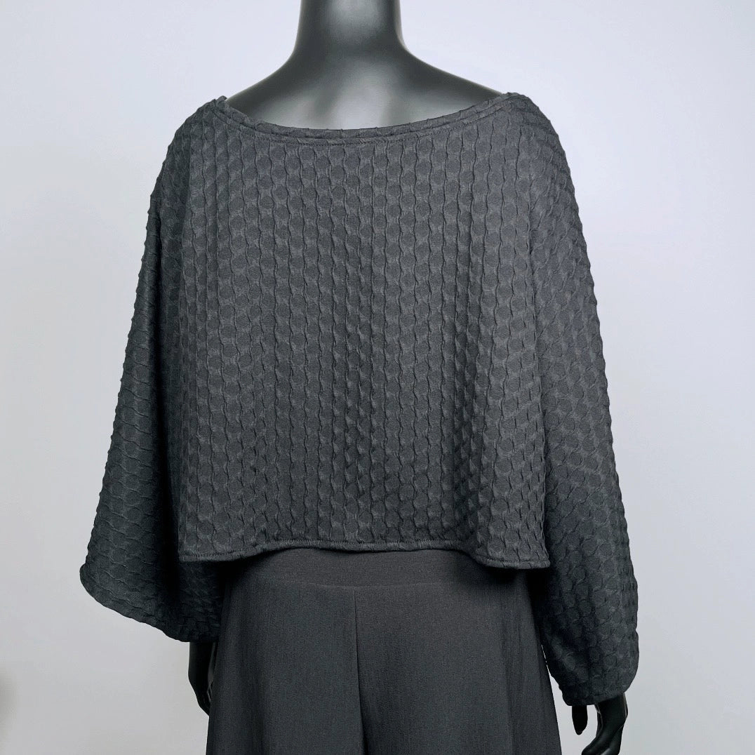Black textured knit top with bat wing sleeves and gathered hemline black rubber necklace made in Melbourne 