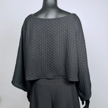 Black textured knit top with bat wing sleeves and gathered hemline black rubber necklace made in Melbourne 