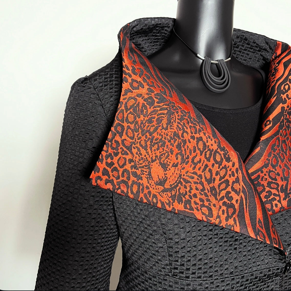 Black jacquard textured jacket with orange and black leopard print patterned collar melbourne made