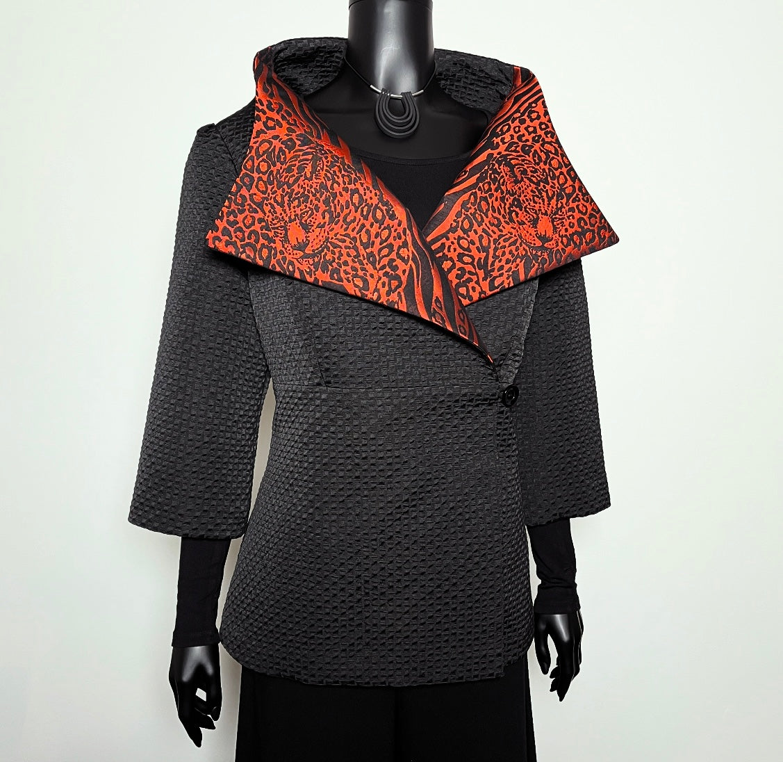 Black jacquard textured jacket with orange and black leopard print patterned collar melbourne made
