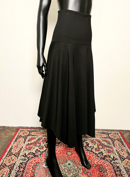 Black skirt on a mannequin against a plain background