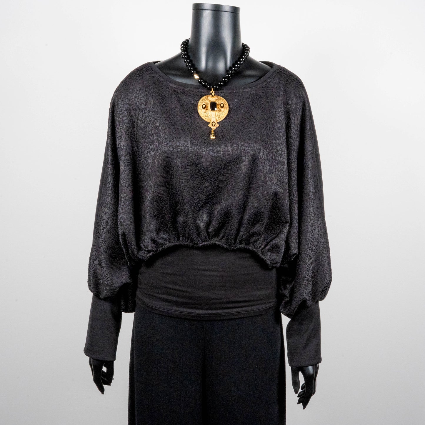 Black bonded lace jacquard top with batwing sleeves layering top gold cross necklace on black onyx beads made in Melbourne Eloise the label