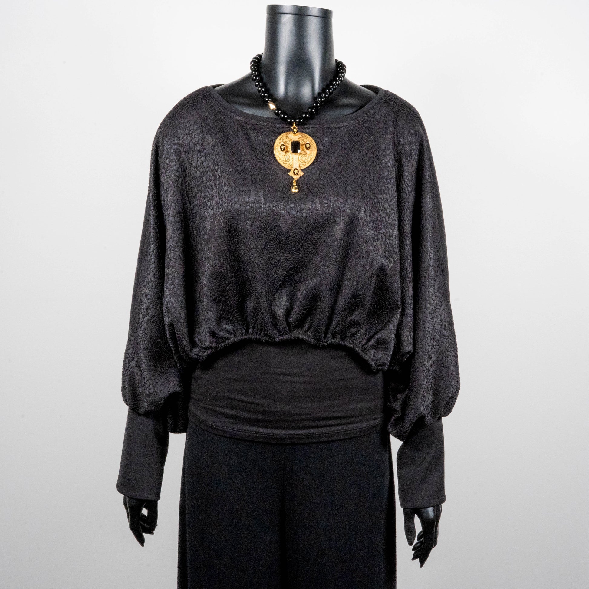 Black bonded lace jacquard top with batwing sleeves layering top gold cross necklace on black onyx beads made in Melbourne Eloise the label