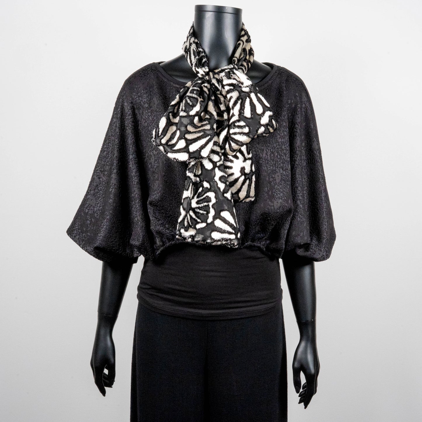 Black bonded lace jacquard top with batwing sleeves layering top gold cross necklace on black onyx beads black and white floral pussy bow made in Melbourne Eloise the label 
