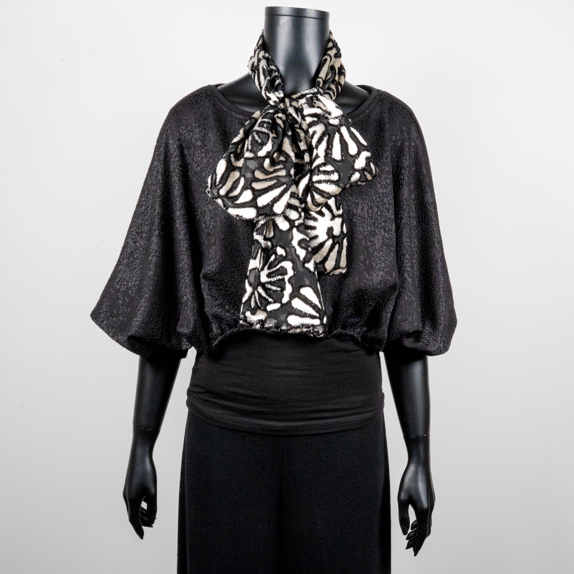Black bonded lace jacquard top with batwing sleeves layering top gold cross necklace on black onyx beads black and white floral pussy bow made in Melbourne Eloise the label 
