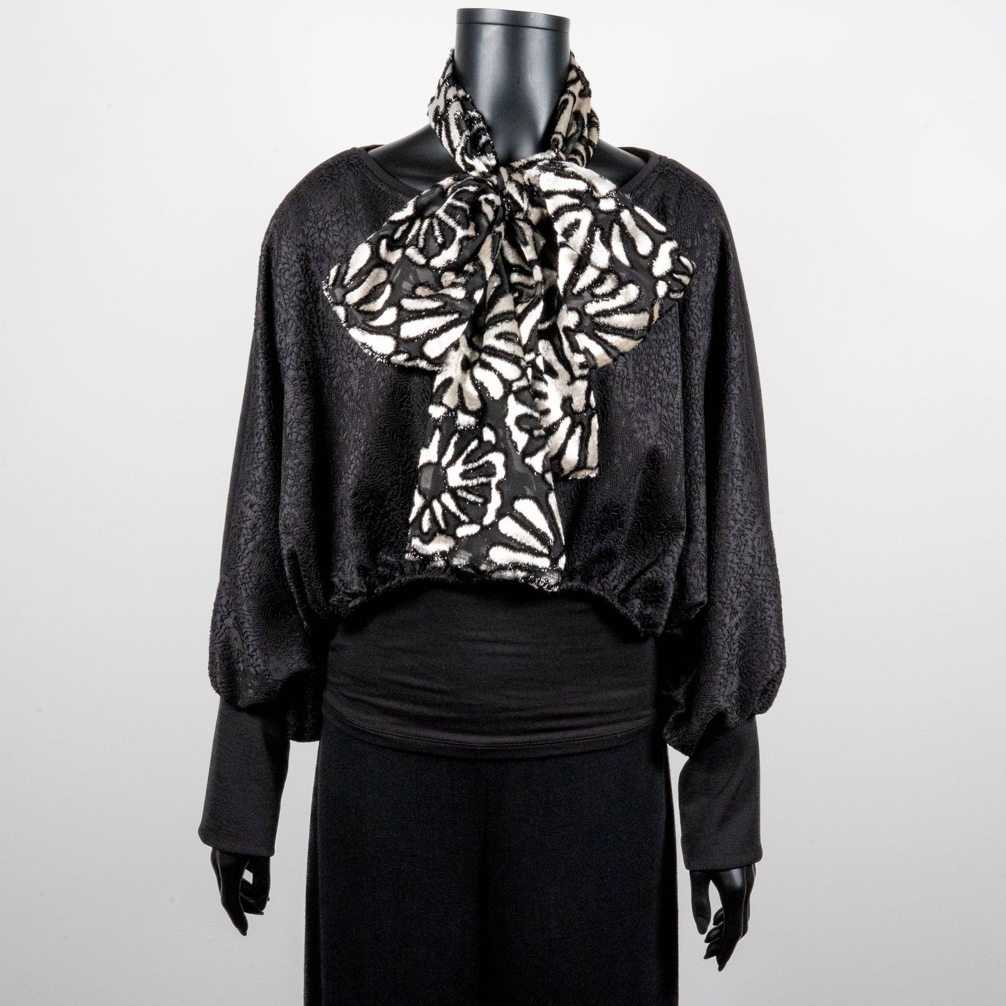 Black bonded lace jacquard top with batwing sleeves layering top gold cross necklace on black onyx beads black and white floral pussy bow made in Melbourne Eloise the label 