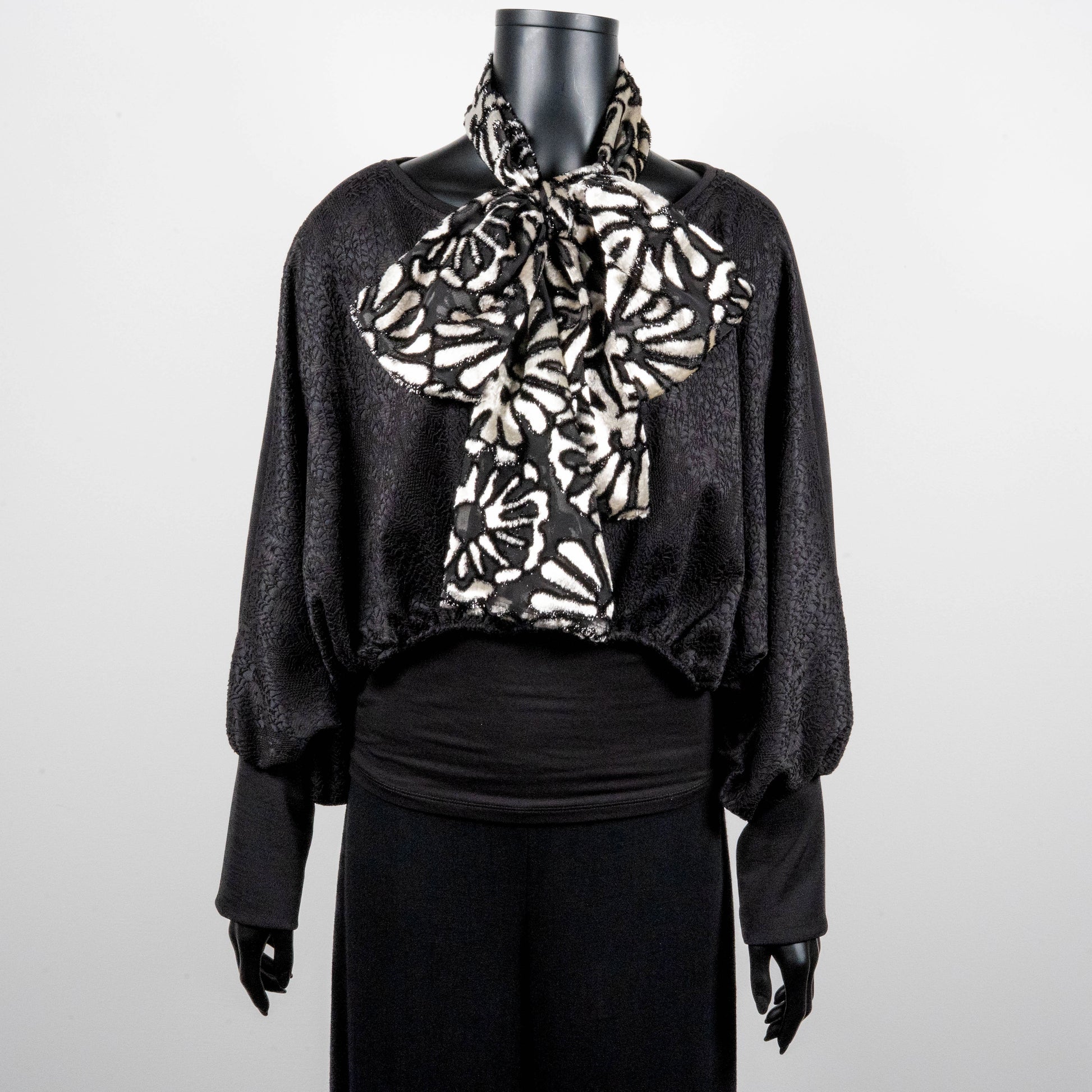 Black bonded lace jacquard top with batwing sleeves layering top gold cross necklace on black onyx beads black and white floral pussy bow made in Melbourne Eloise the label 