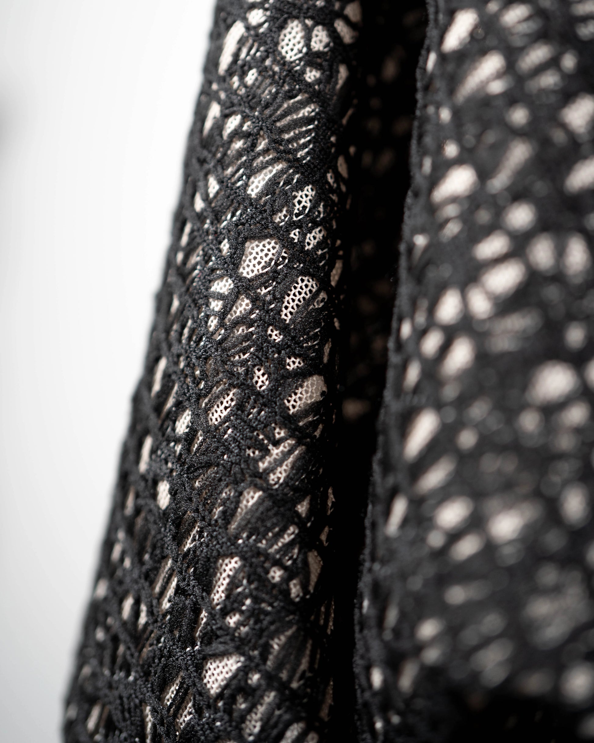 Black mesh jacquard top with bat wing sleeves and gathered hemline black rubber necklace made in Melbourne Eloise the label