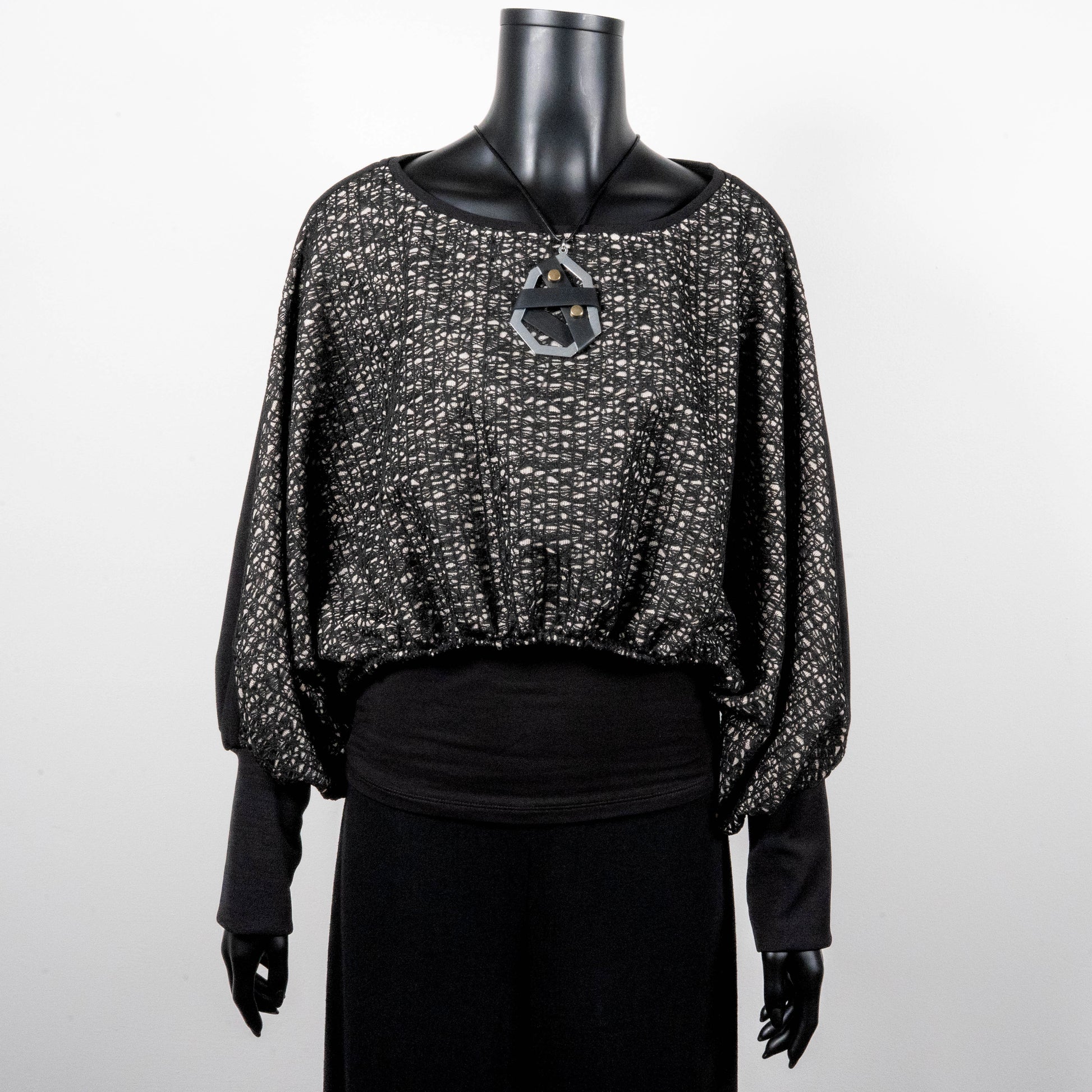 Black mesh jacquard top with bat wing sleeves and gathered hemline black rubber necklace made in Melbourne Eloise the label