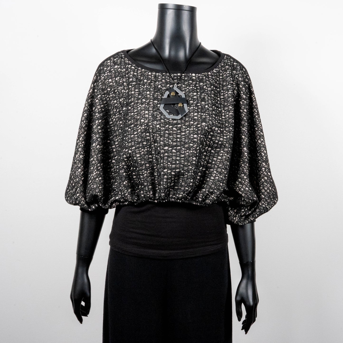 Black mesh jacquard top with bat wing sleeves and gathered hemline black rubber necklace made in Melbourne Eloise the label