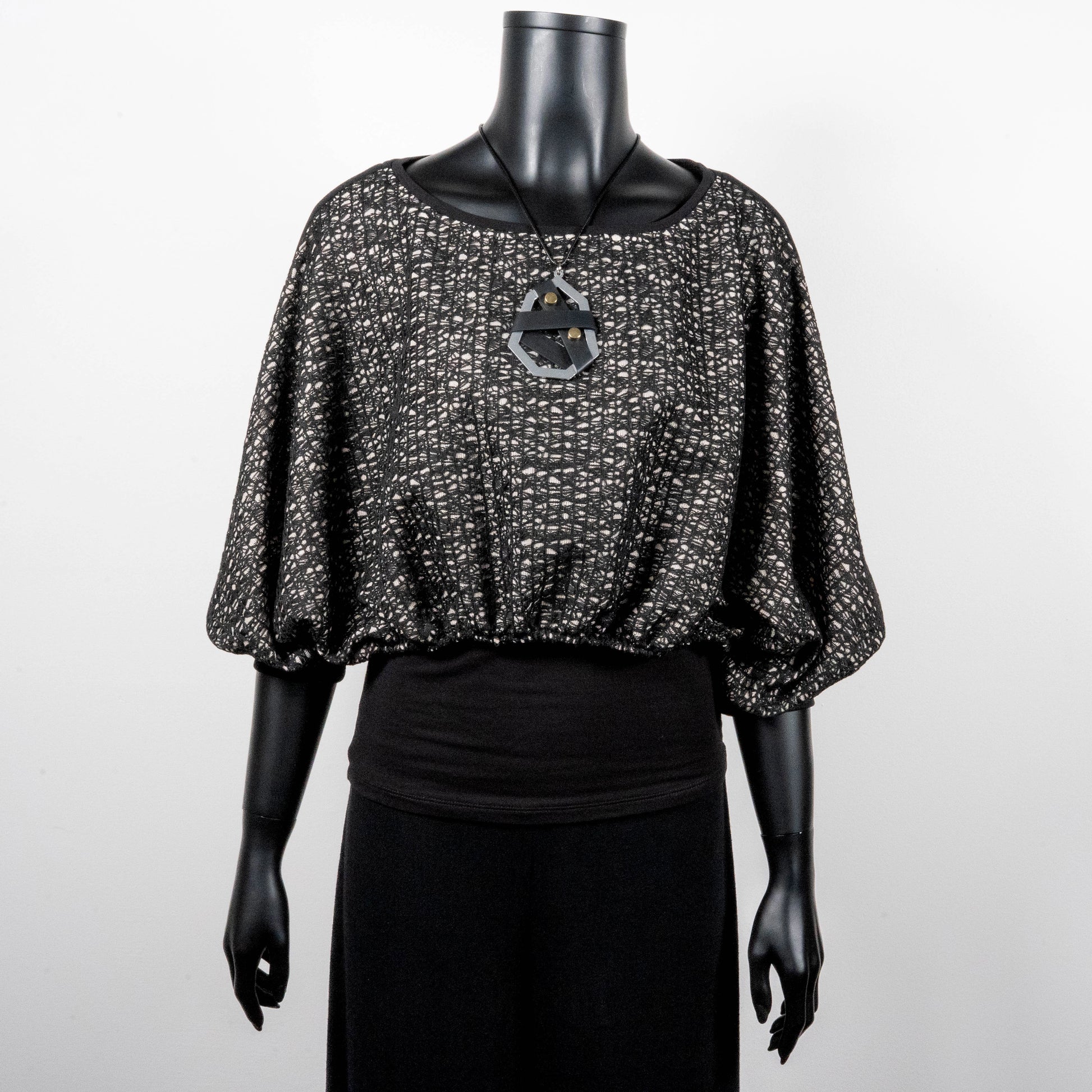 Black mesh jacquard top with bat wing sleeves and gathered hemline black rubber necklace made in Melbourne Eloise the label