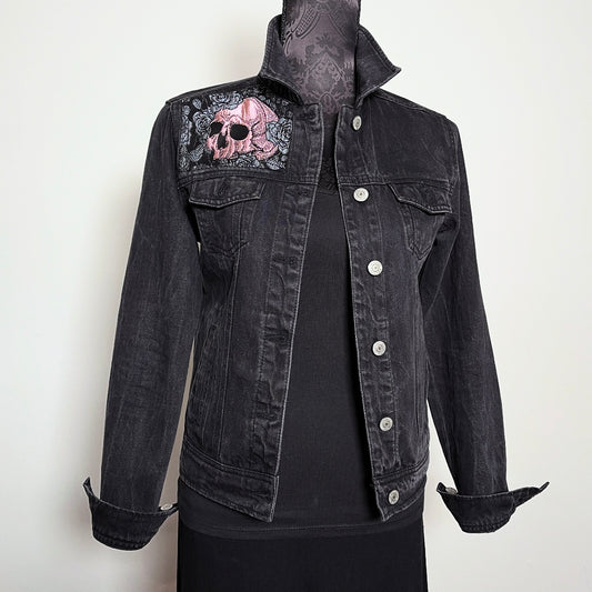 Upcycled black denim jacket with skulls and roses in pink