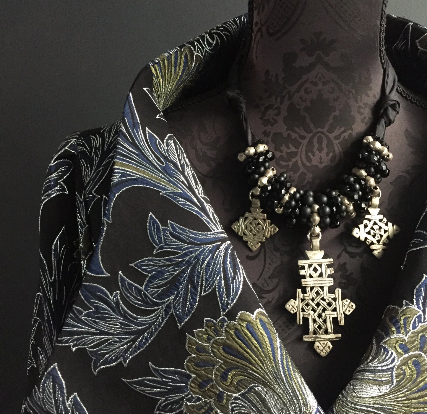 Cross necklace on silk tie in silver