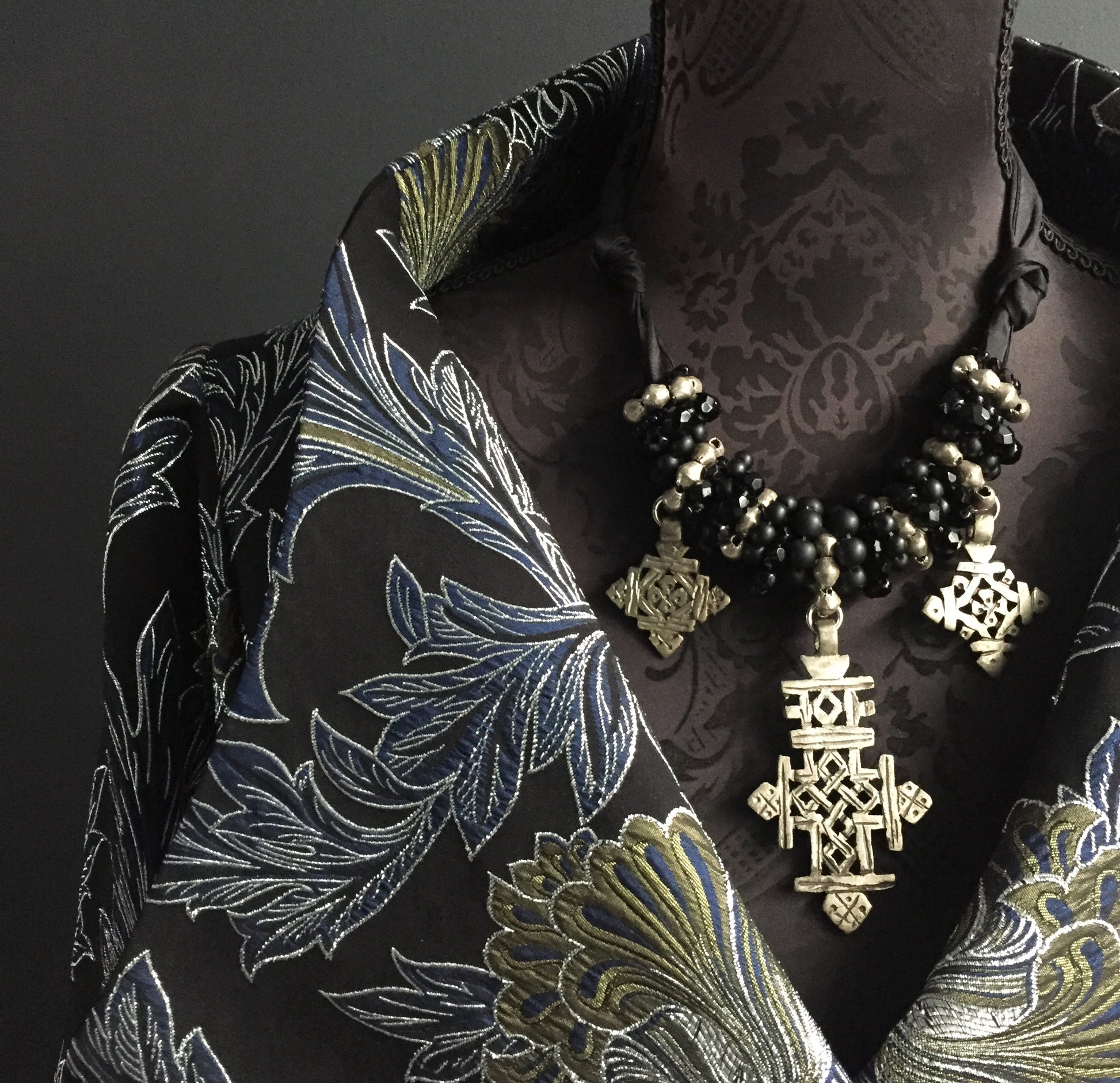 Cross necklace on silk tie in silver